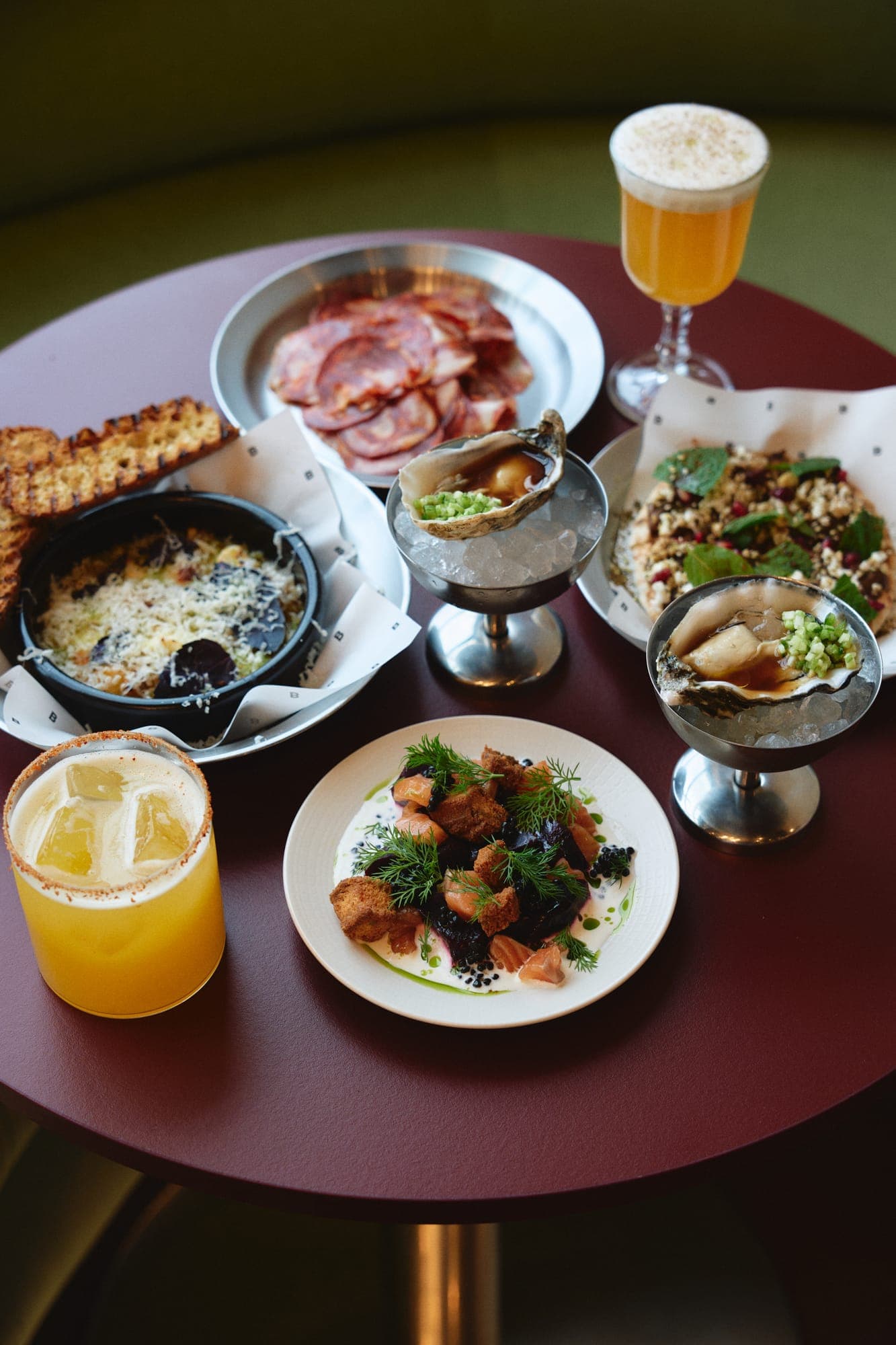 Table spread of small plates, charcuterie and drinks